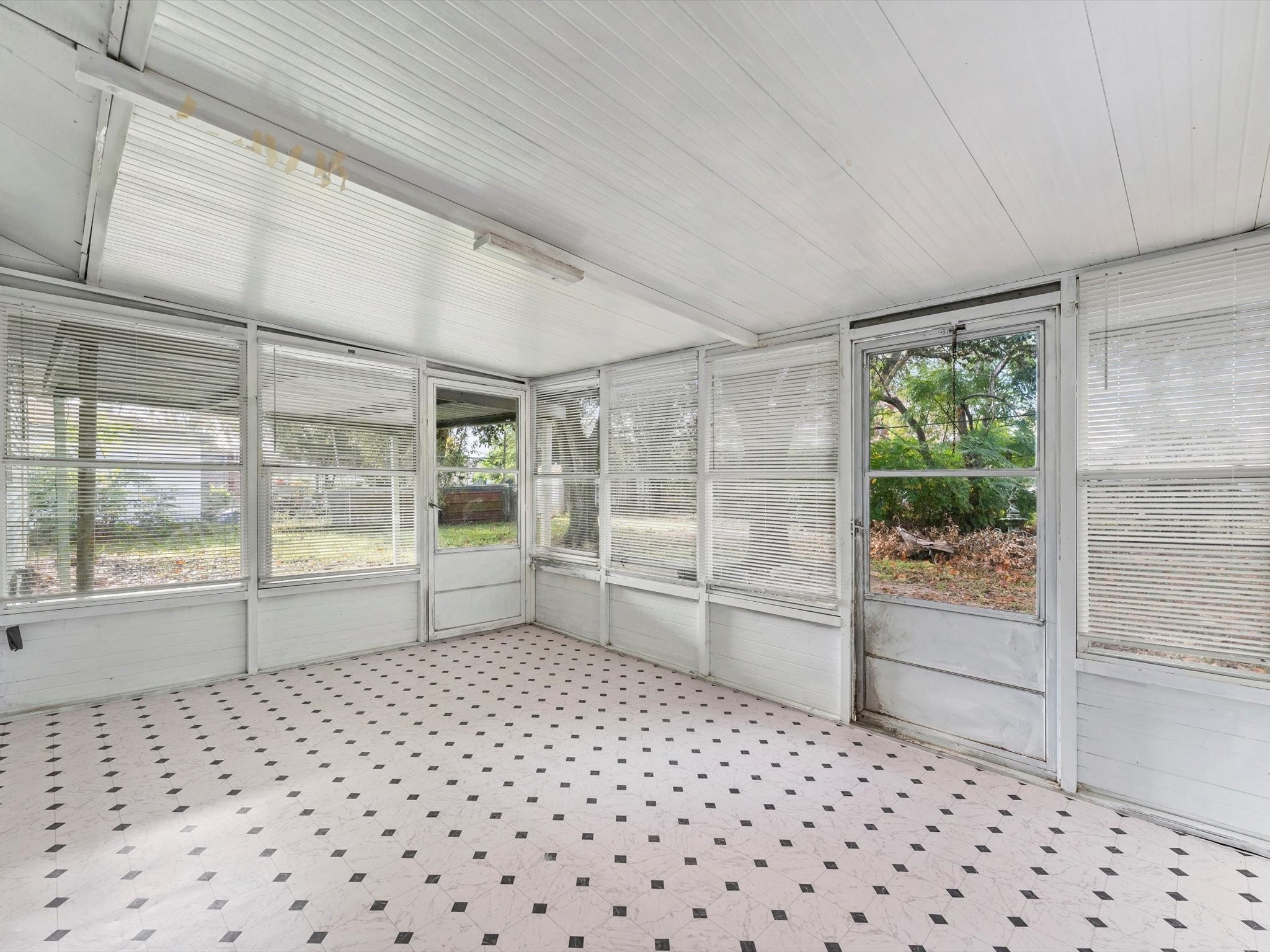 10918 Ritow Street Houston, TX 77089 - Photo 19 of 26 a room with a black white checkered floor with a large window