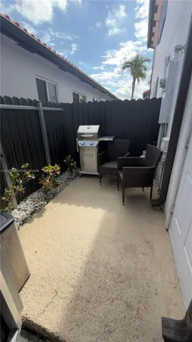 a backyard of a house with table and chairs