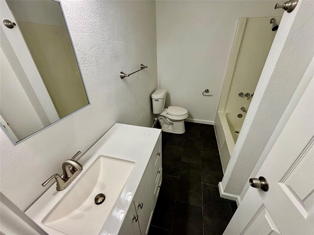 607 Baylor Street Nocona, TX 76255 - Photo 12 of 17 a bathroom with a sink and a mirror