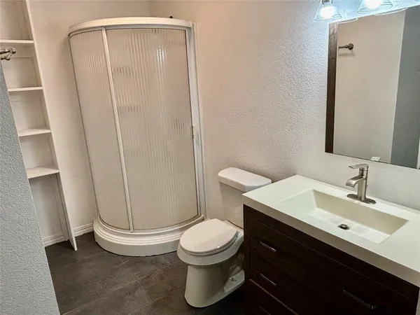 a bathroom with a toilet a sink and a mirror