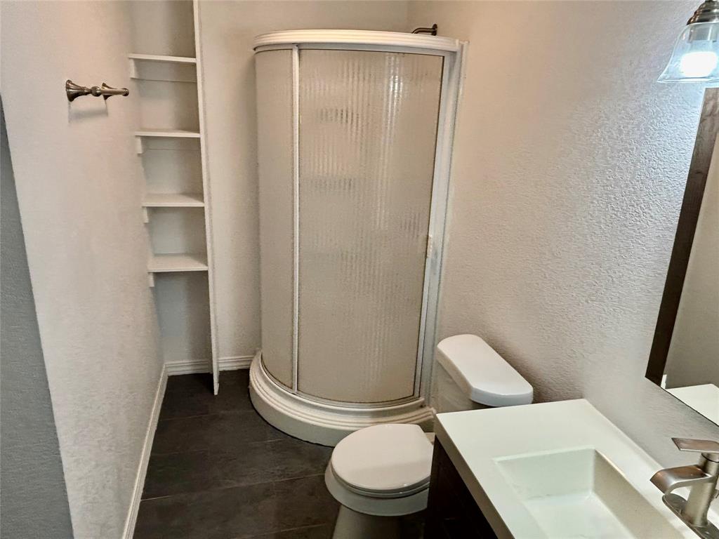 607 Baylor Street Nocona, TX 76255 - Photo 4 of 17 a white toilet sitting next to a shower