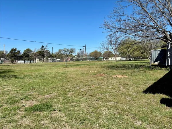 a view of a field with an ocean