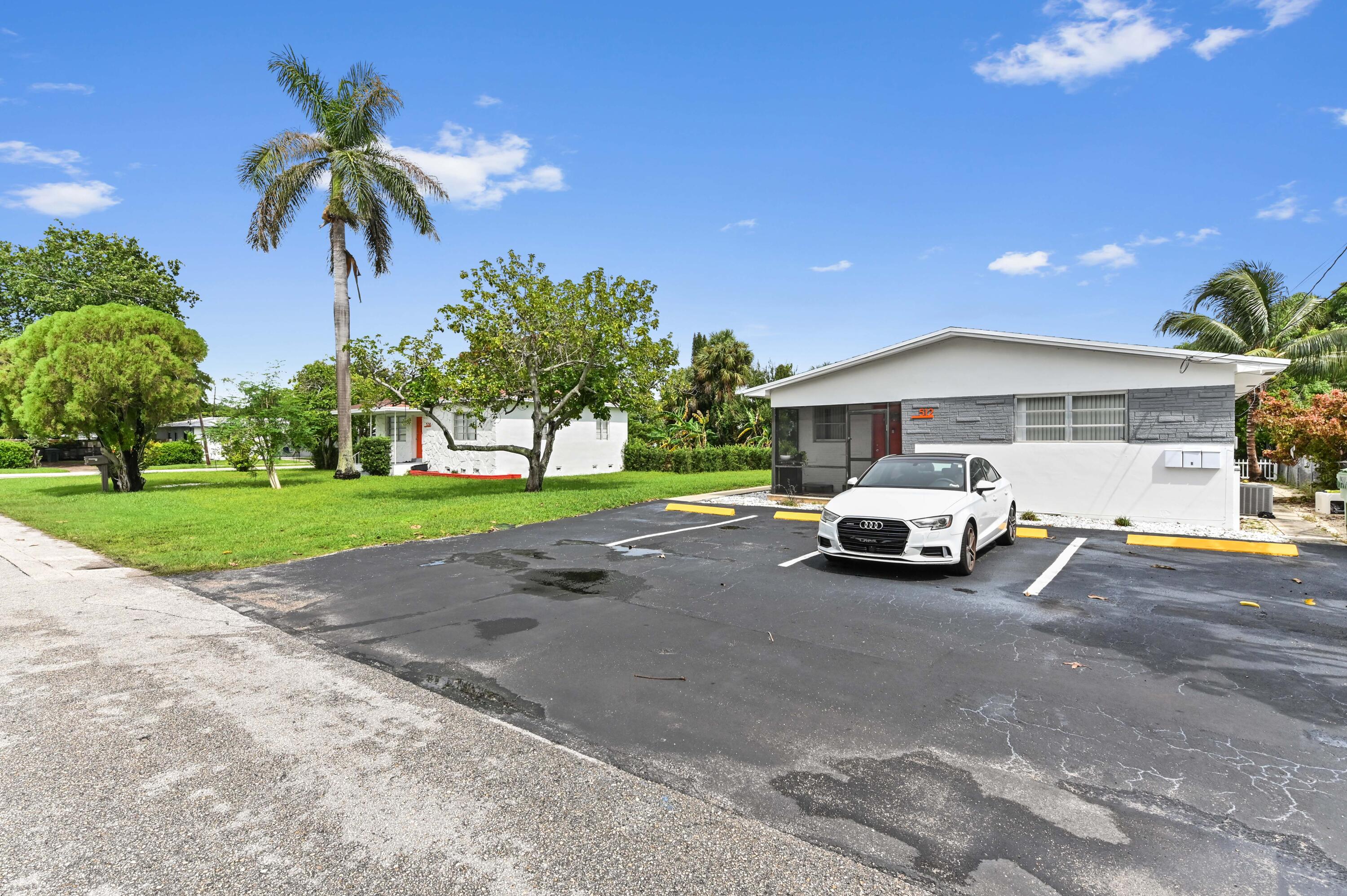 a view of a house with a cars park