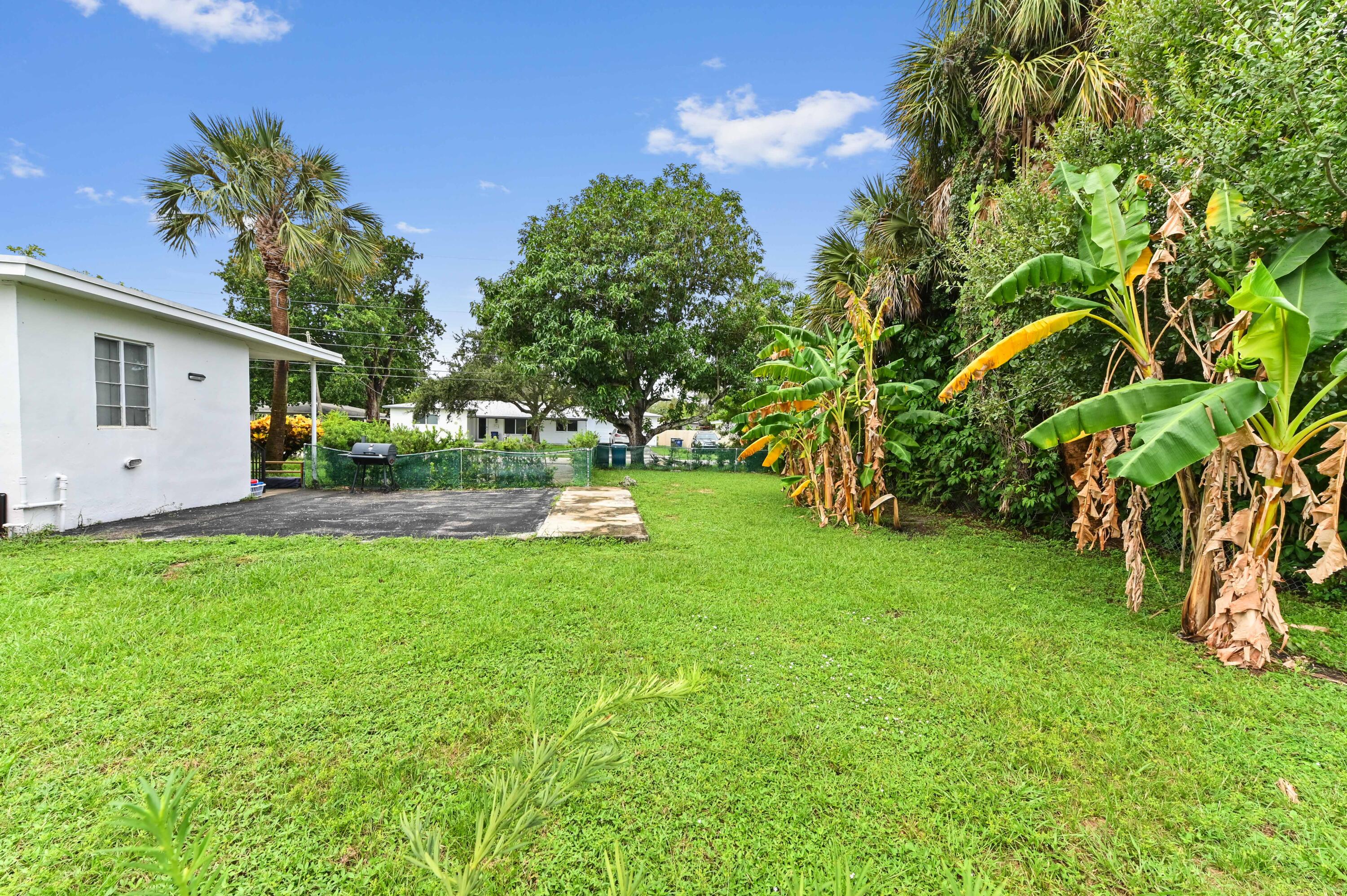 538 Southwest 7th Street Hallandale Beach, FL 33009 - Photo 13 of 35 a view of a house with backyard and a tree