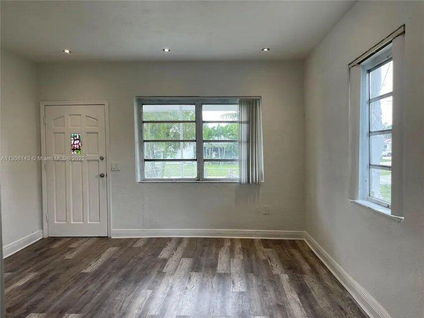 538 Southwest 7th Street Hallandale Beach, FL 33009 - Photo 19 of 35 an empty room with wooden floor and windows