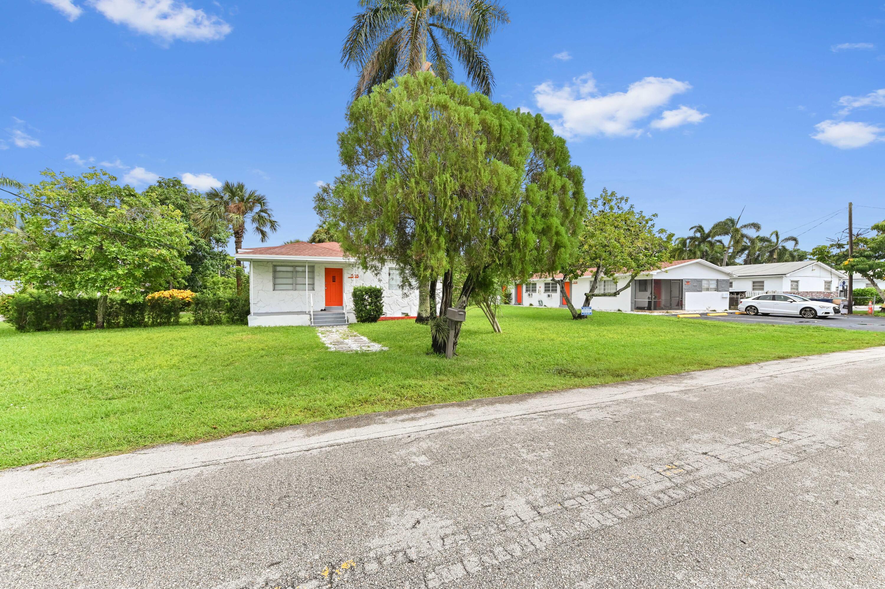 538 Southwest 7th Street Hallandale Beach, FL 33009 - Photo 2 of 35 a house with green field in front of it