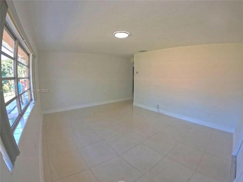 538 Southwest 7th Street Hallandale Beach, FL 33009 - Photo 25 of 35 an empty room with windows and entrance