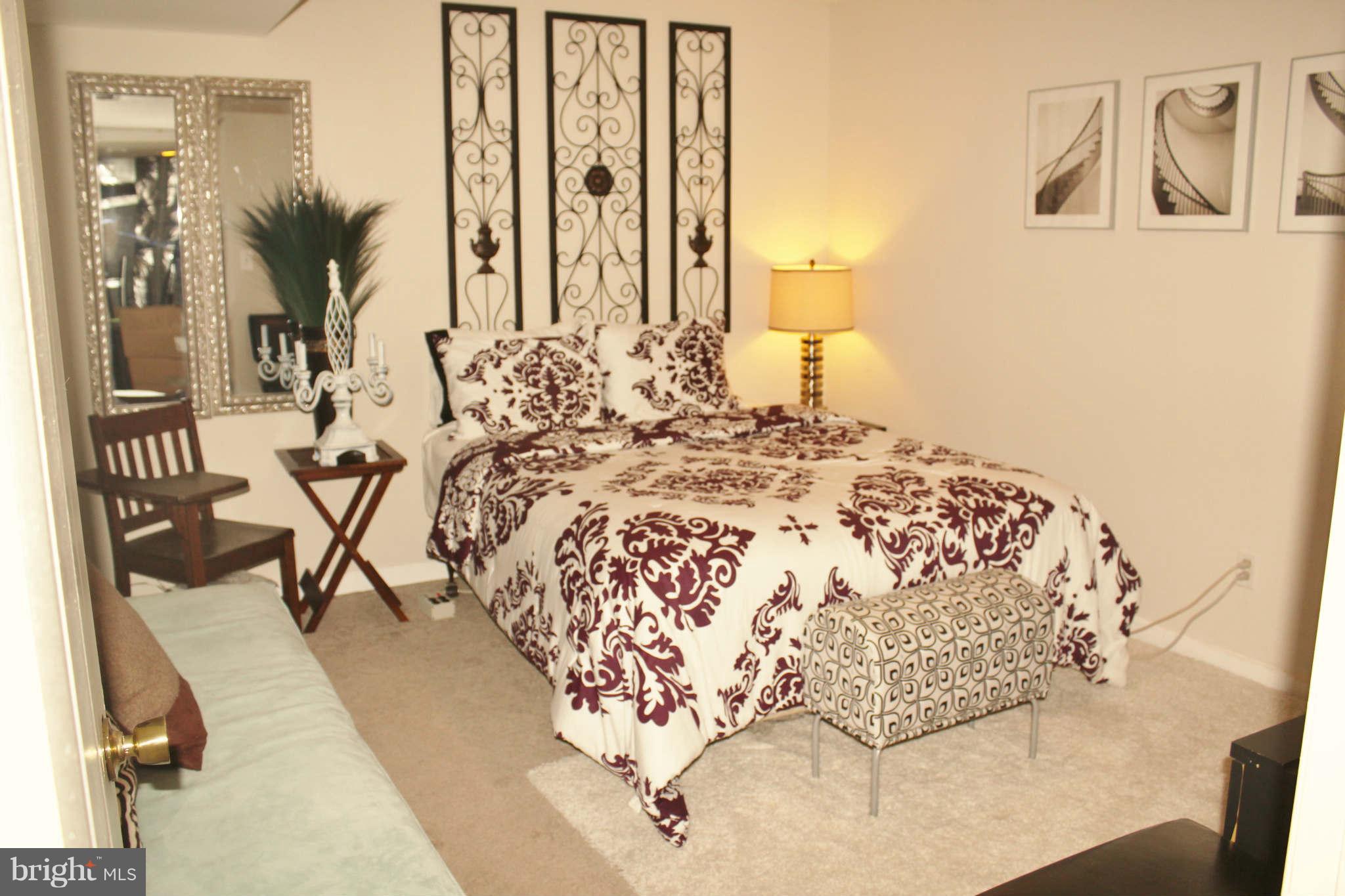 43396 Edgewater Street Chantilly, VA 20152 - Photo 14 of 16 a bed sitting in a bedroom next to a bathroom