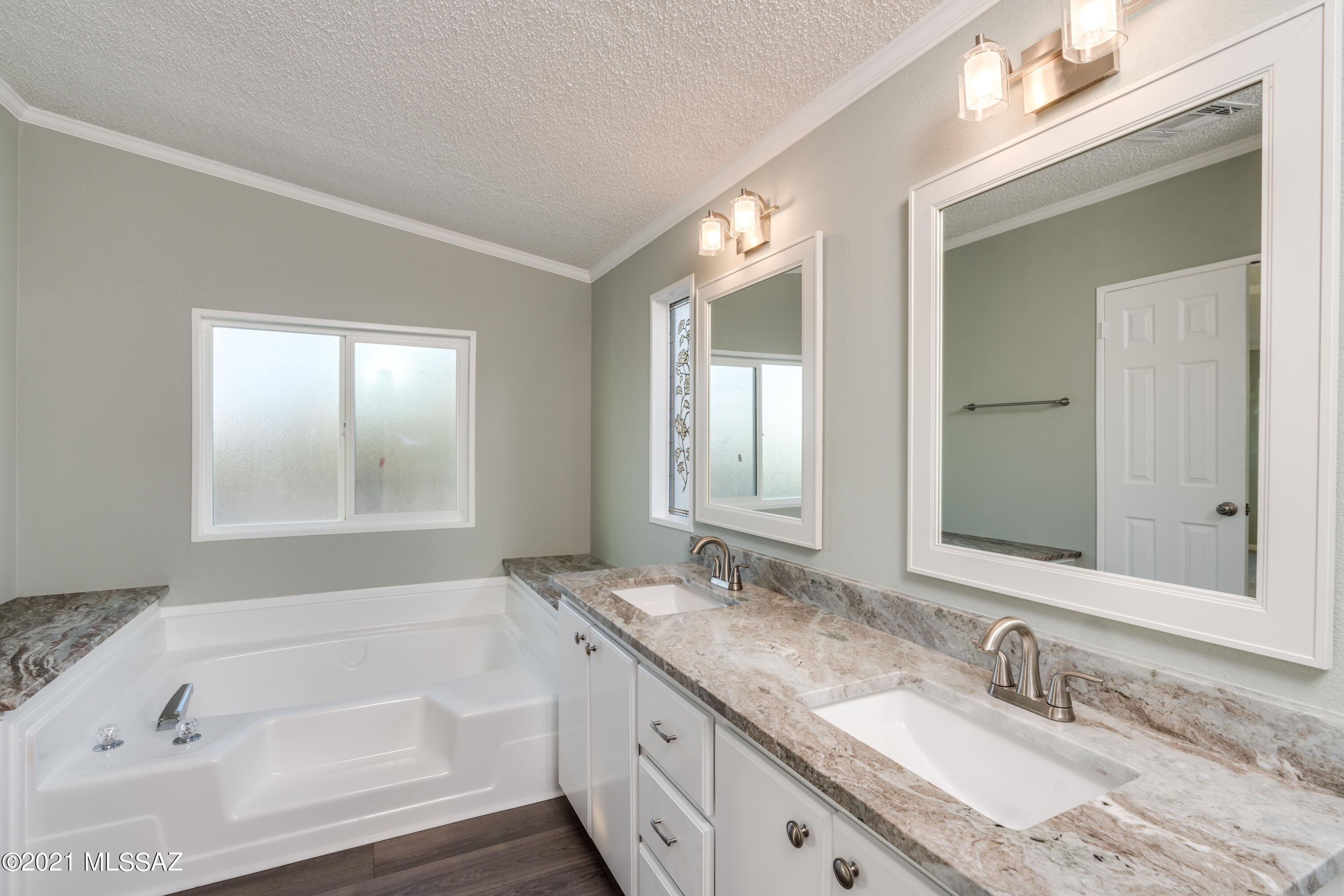 4489 East Wilds Road Tucson, AZ 85739 - Photo 35 of 50 a bathroom with a granite countertop tub sink and mirror