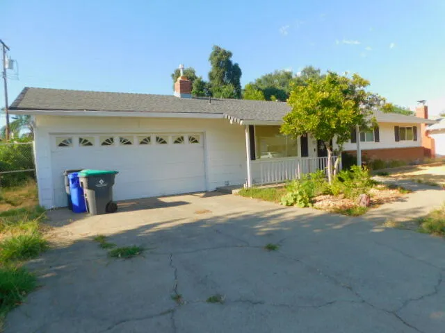 a view of a house with a yard and a garage