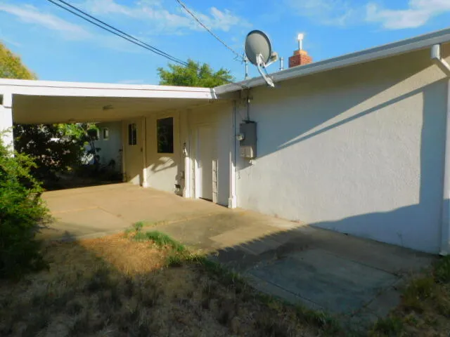 a front view of a house with swimming pool and sitting area