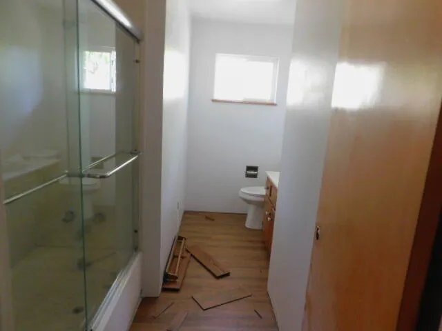 an empty room with a chandelier fan