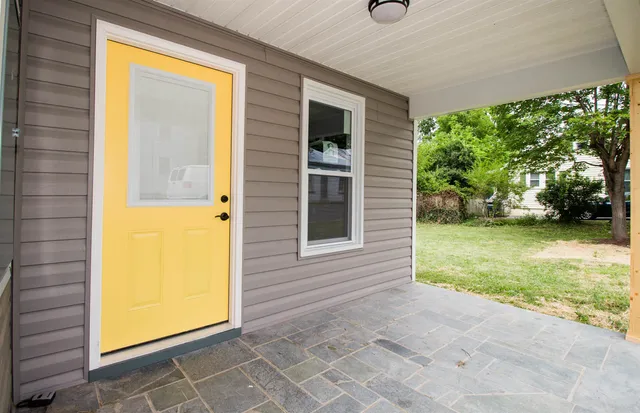 a view of backyard with large trees and plants