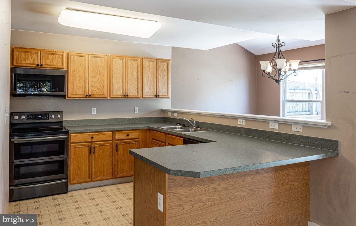 2 Kimberly Drive Middletown, DE 19709 - Photo 13 of 32 a kitchen with stainless steel appliances granite countertop a sink a stove and a refrigerator
