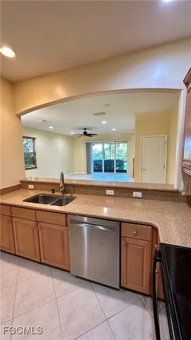 a large kitchen with a sink and cabinets