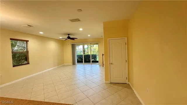 a view of a hallway with wooden floor and a bathroom