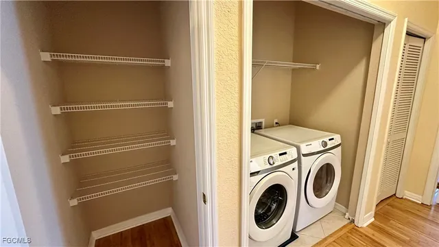 a view of room with a ceiling fan and wooden floor