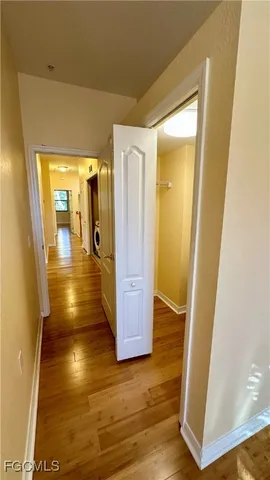 a view of a livingroom with wooden floor and a ceiling fan