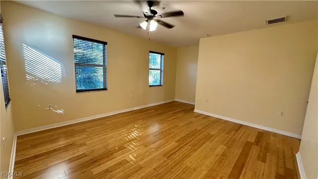 a view of empty room with wooden floor