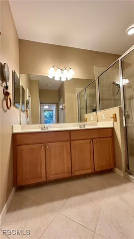 a bathroom with a double vanity sink and mirror
