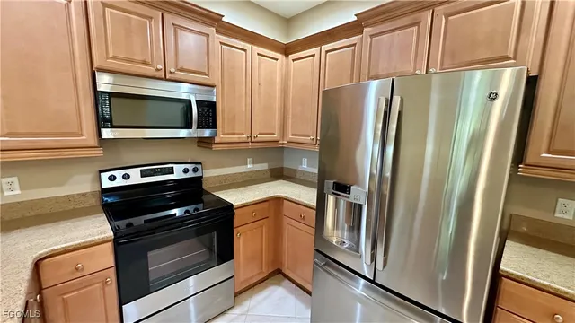 a kitchen with stainless steel appliances a refrigerator stove and microwave