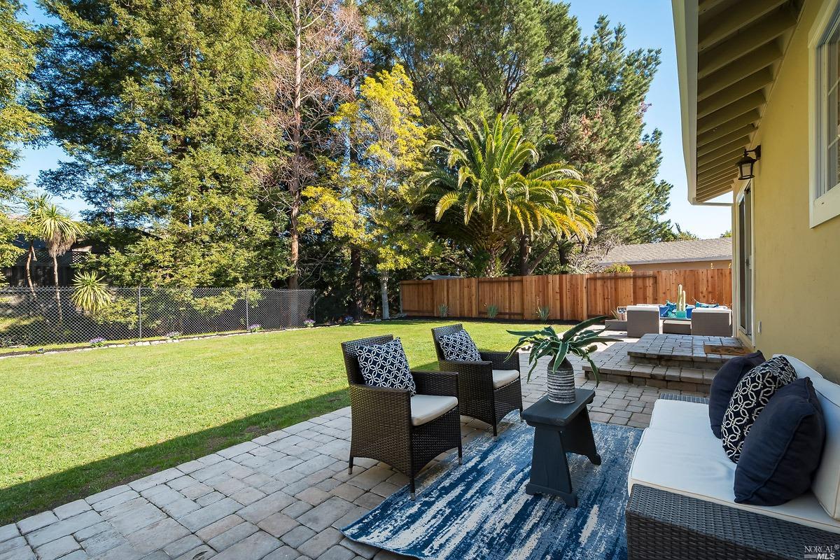 a view of a couches in the patio with a small yard