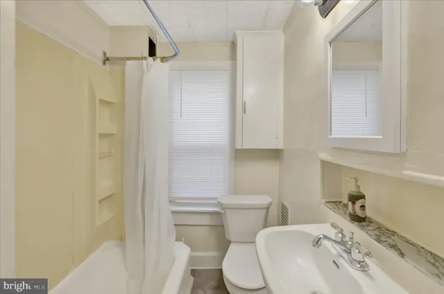 a white toilet sitting next to a bathroom sink