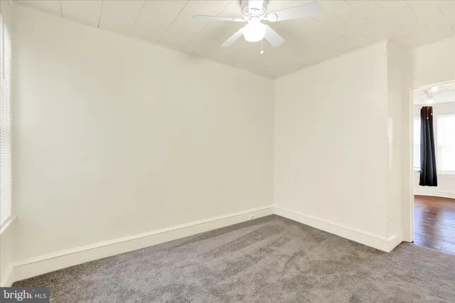 an empty room with a empty space and a ceiling fan