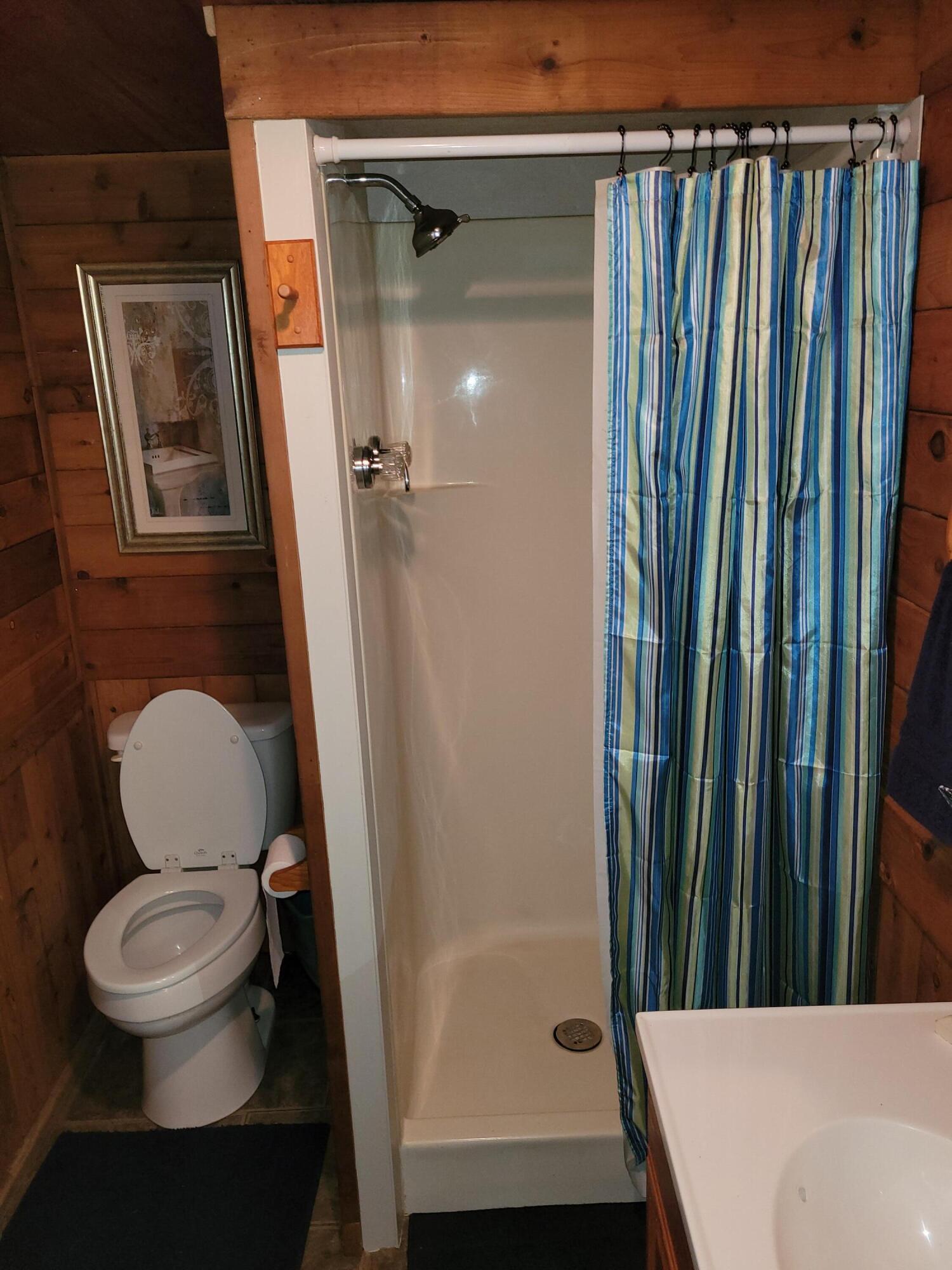 7363 Beaver Creek Road Baker, FL 32531 - Photo 11 of 29 a bathroom with a toilet and a shower