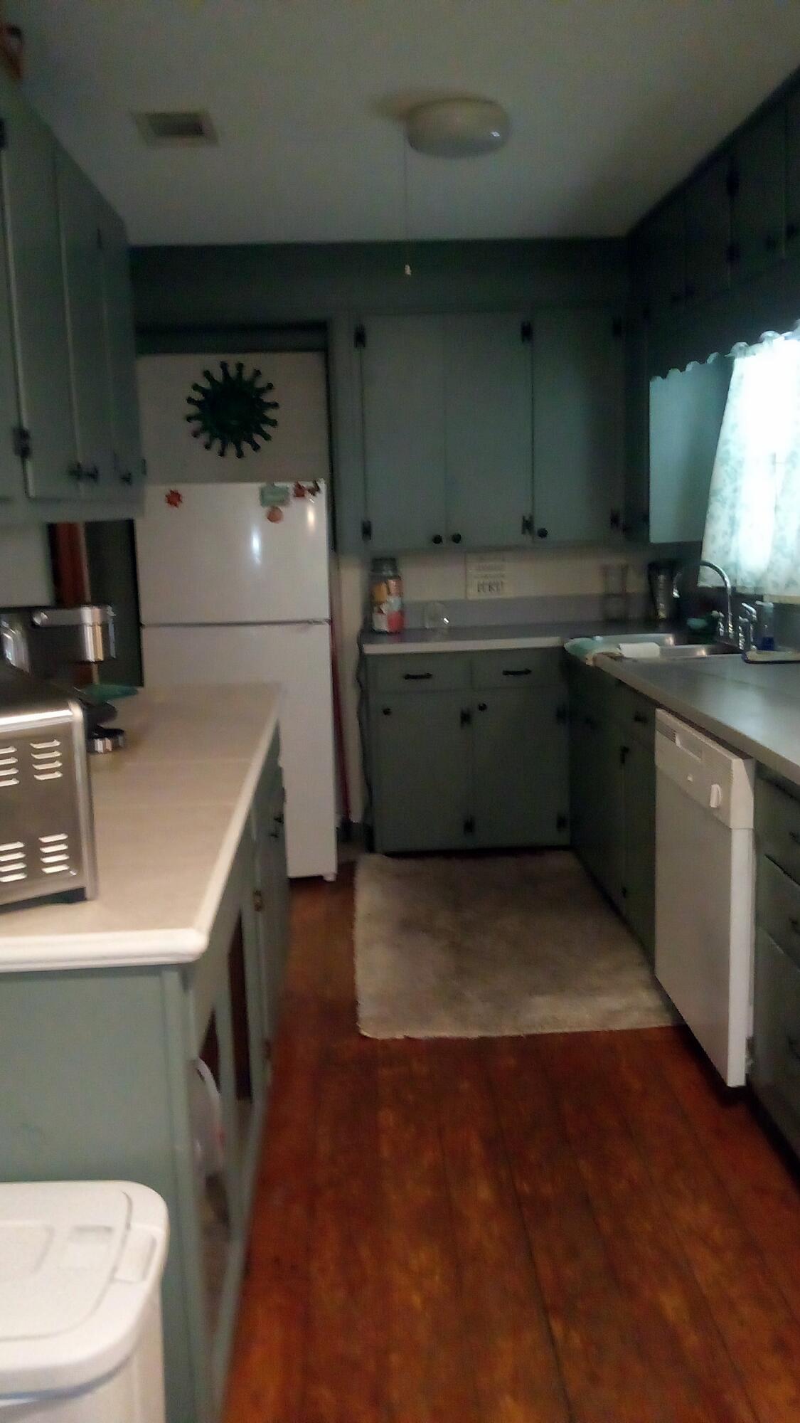 7363 Beaver Creek Road Baker, FL 32531 - Photo 13 of 29 a kitchen with sink a refrigerator and a stove