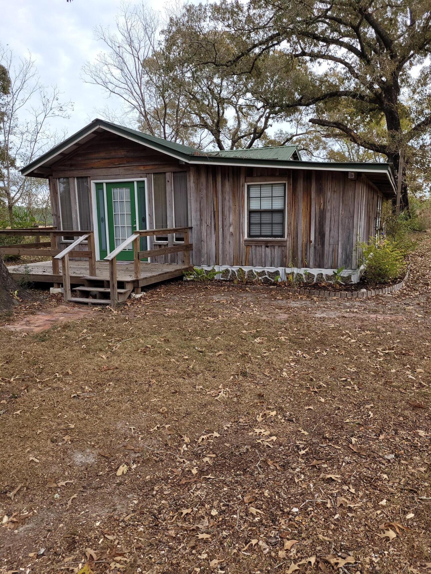 7363 Beaver Creek Road Baker, FL 32531 - Photo 28 of 29 a front view of a house with garden