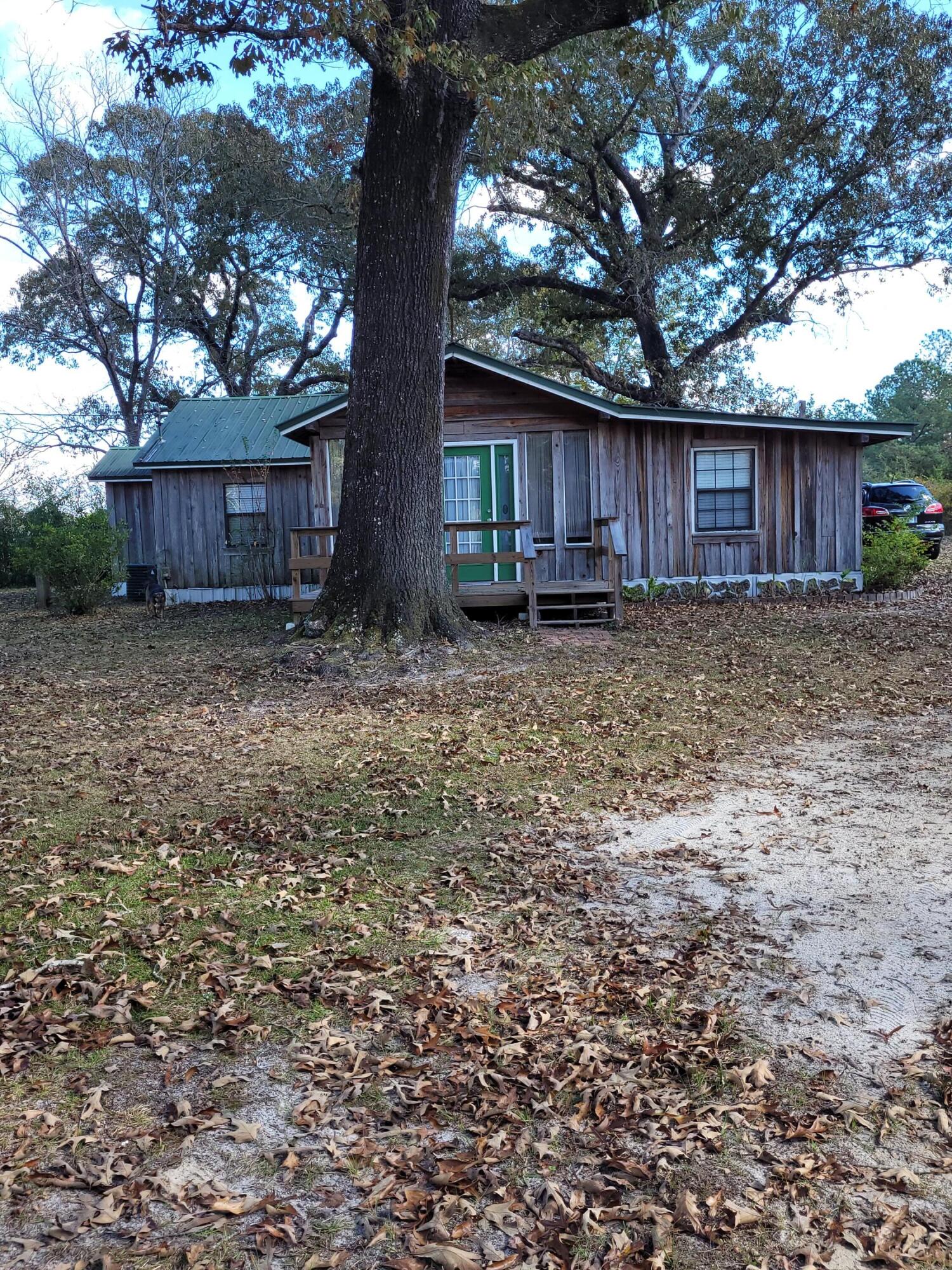 7363 Beaver Creek Road Baker, FL 32531 - Photo 29 of 29 a view of a barn in the middle of a yard
