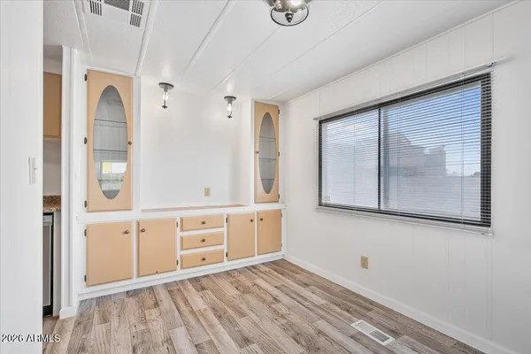 a view of a hallway with closet and mirror