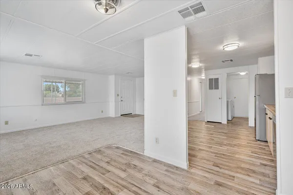 a view of a big room with wooden floor and a bathroom