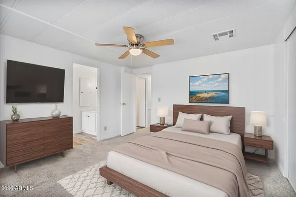 a bedroom with a bed and a flat screen tv