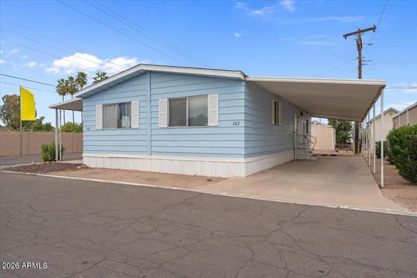 a view of a house with a backyard and garage