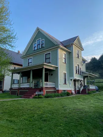 a front view of house with yard and green space