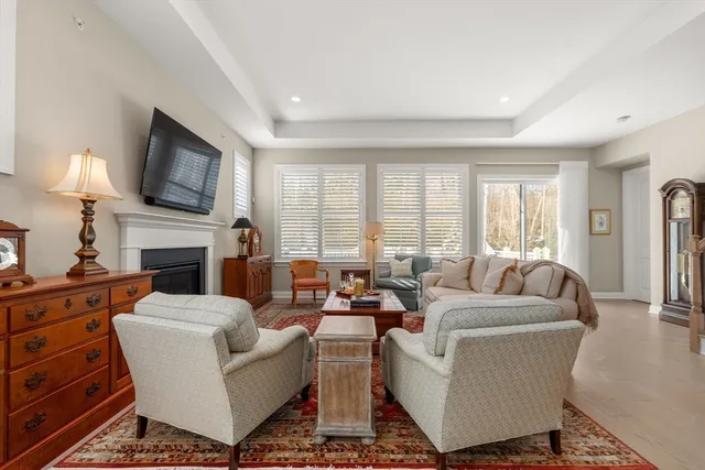 a living room with furniture fireplace and flat screen tv