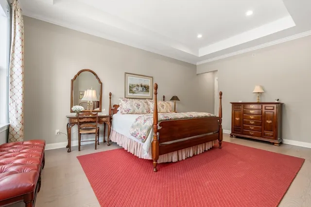 a bedroom with a bed couch and a fireplace