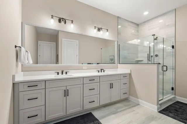 a bathroom with a double vanity sink mirror and double