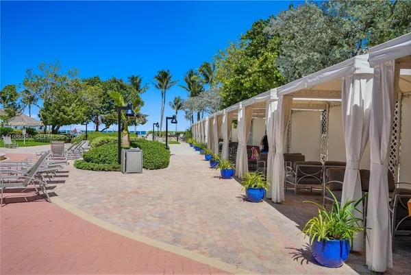 an outdoor space with patio and white umbrellas