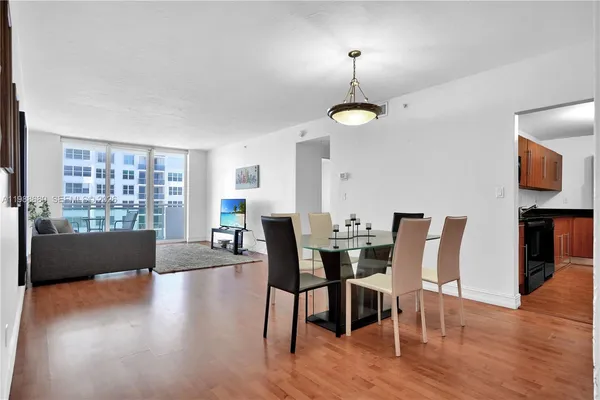 a view of a dining room with furniture window and wooden floor