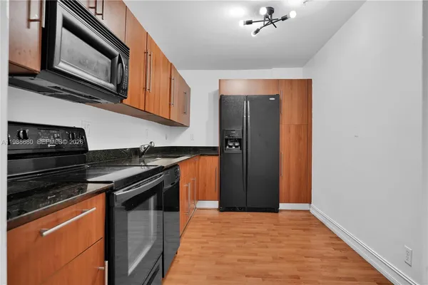 a kitchen with stainless steel appliances granite countertop a stove and a microwave