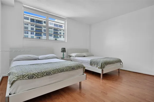 a bedroom with a bed and a night stand