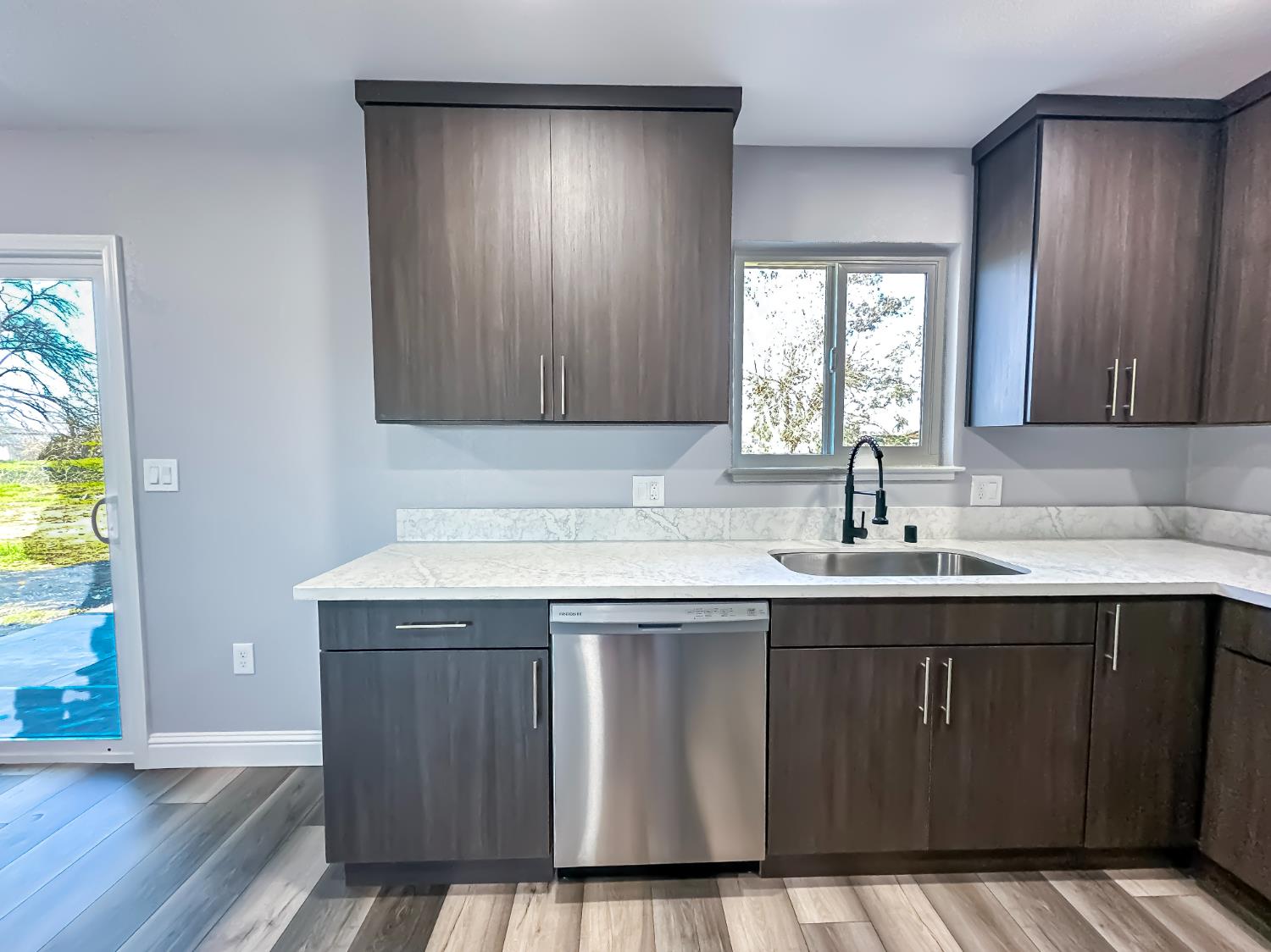 4804 Powerline Road Olivehurst, CA 95961 - Photo 25 of 65 a kitchen with a sink window and cabinets