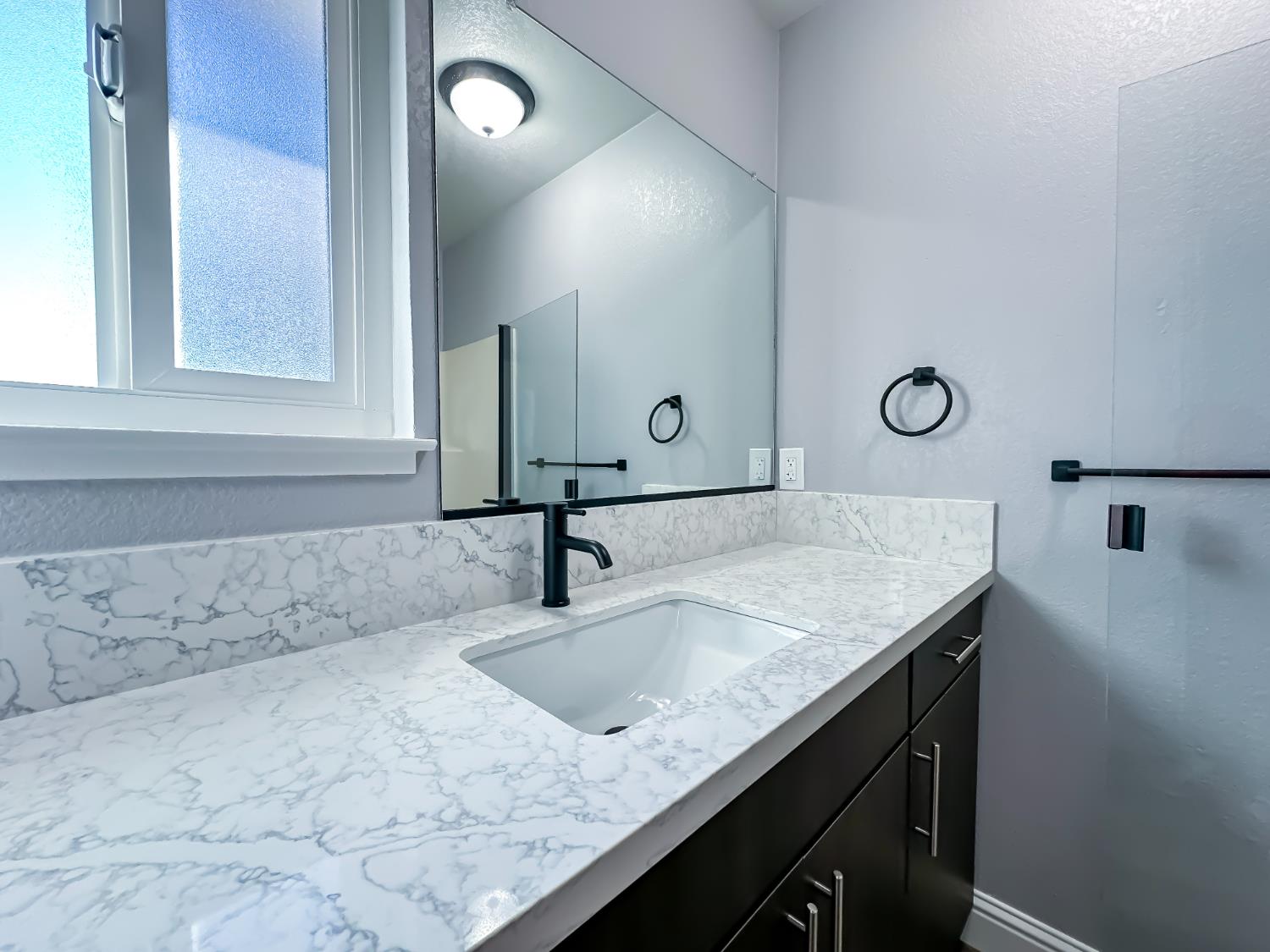 4804 Powerline Road Olivehurst, CA 95961 - Photo 34 of 65 a bathroom with a granite countertop sink and a mirror