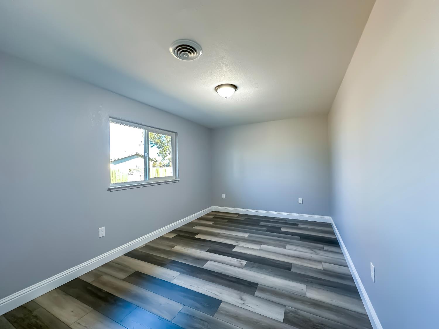 4804 Powerline Road Olivehurst, CA 95961 - Photo 45 of 65 a view of room with window and wooden floor