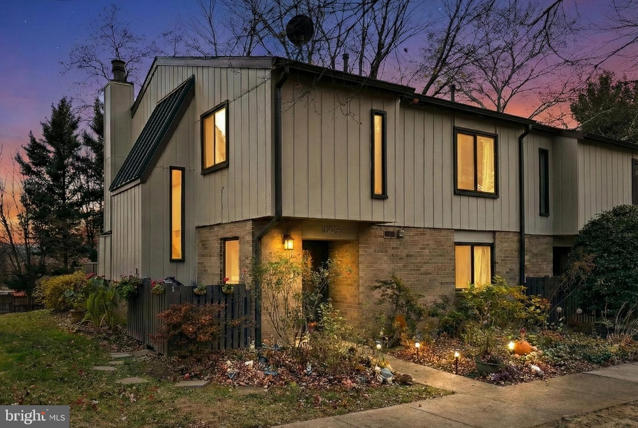 1809 Ivy Oak Square, Unit 61 Reston, VA 20190 - Photo 1 of 38 a front view of a house with garden