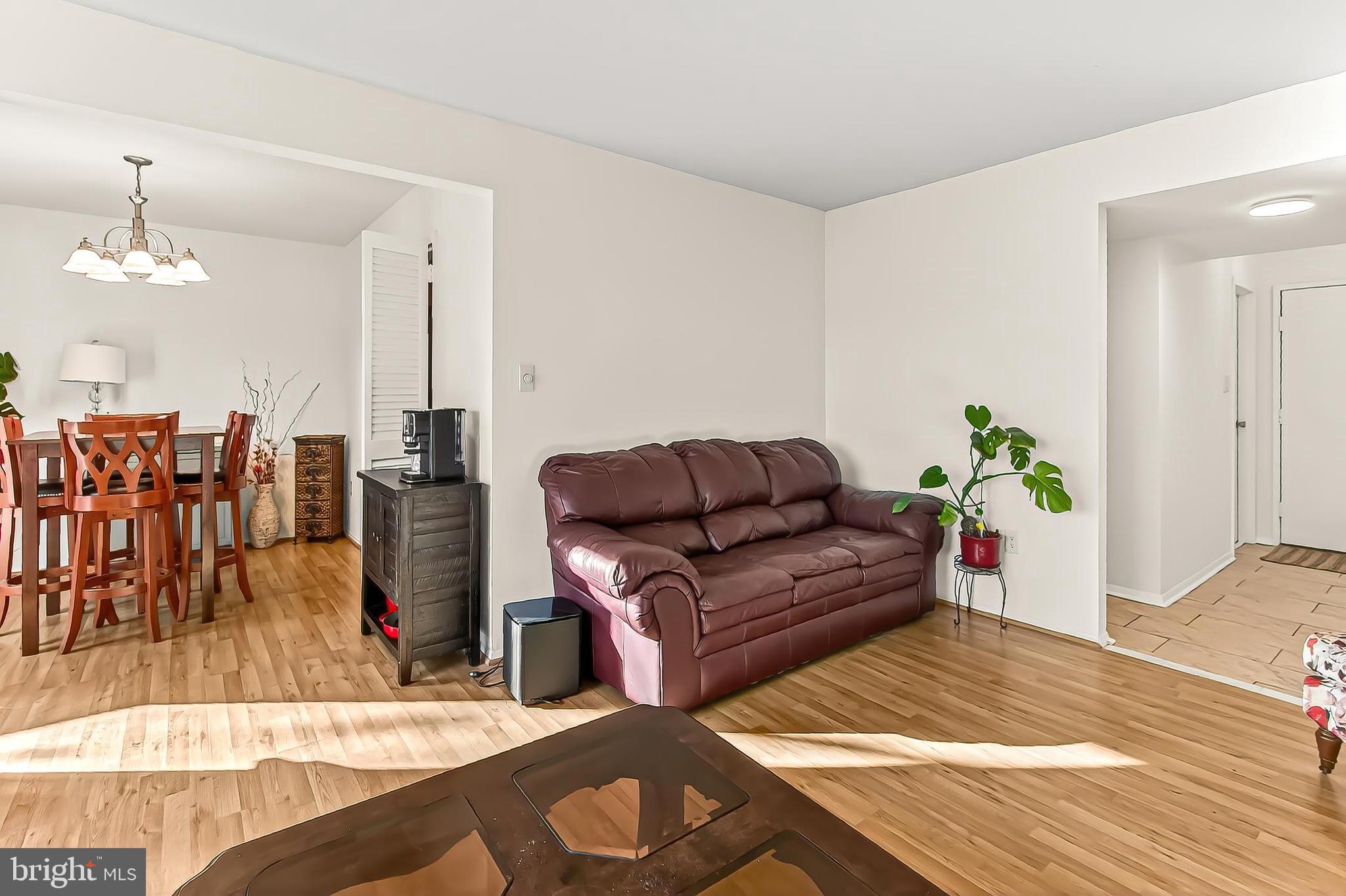 1809 Ivy Oak Square, Unit 61 Reston, VA 20190 - Photo 11 of 38 a living room with furniture and wooden floor