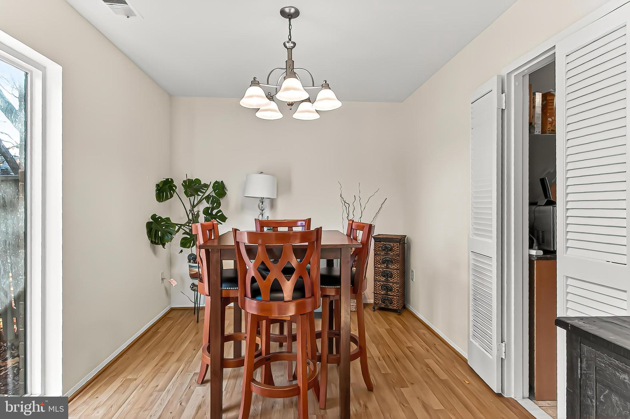 1809 Ivy Oak Square, Unit 61 Reston, VA 20190 - Photo 12 of 38 a view of a dining room with furniture and wooden floor